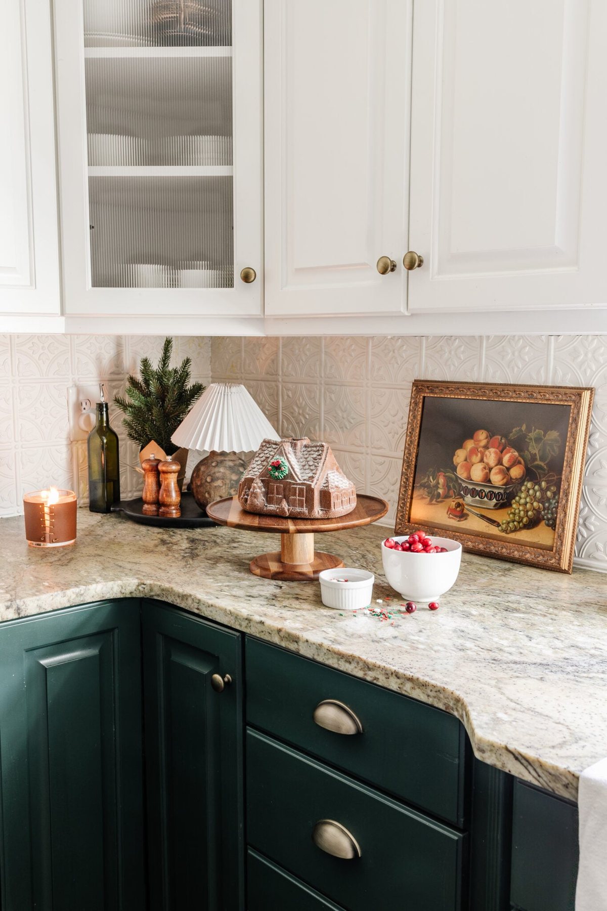 fake gingerbread house cake and mini lamp on kitchen countertop