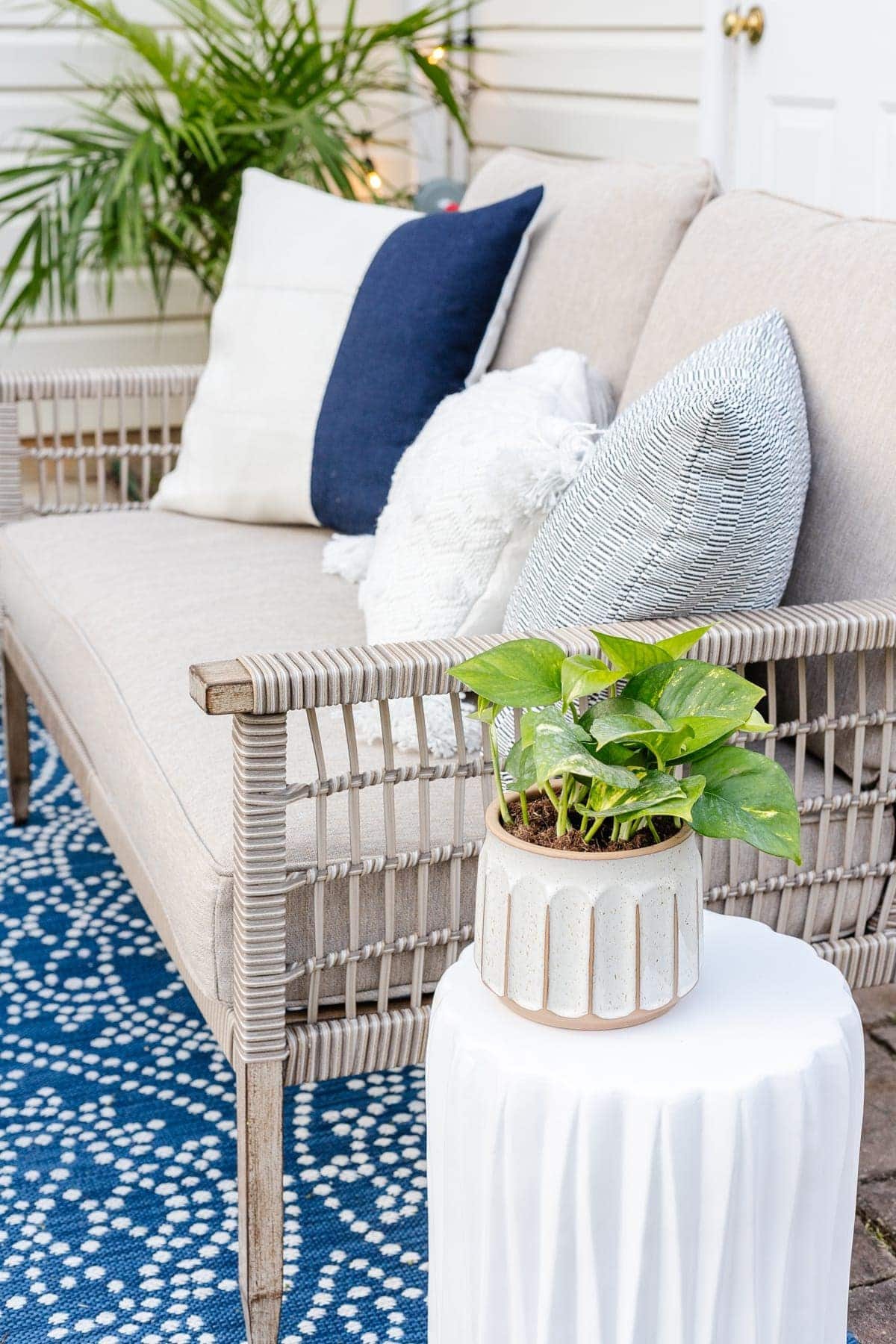 outdoor sofa with pillows and plants