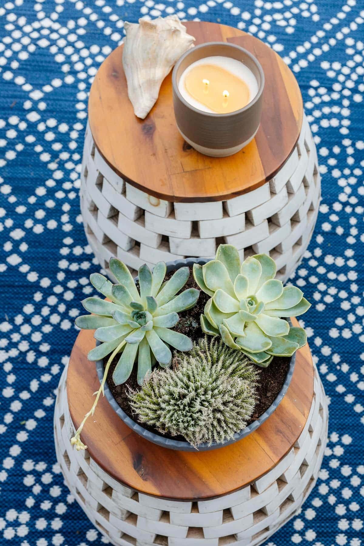 garden stools used as tables with plants and candles on top