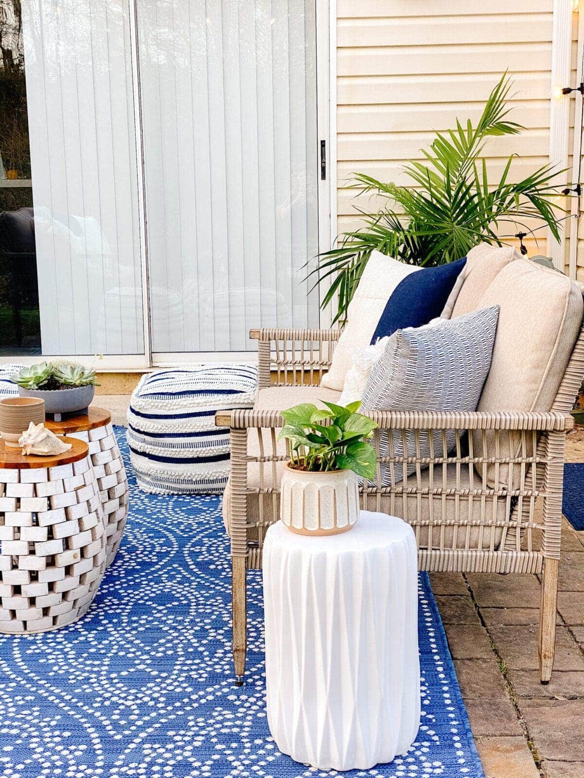 outdoor loveseat with garden stool tables and plants