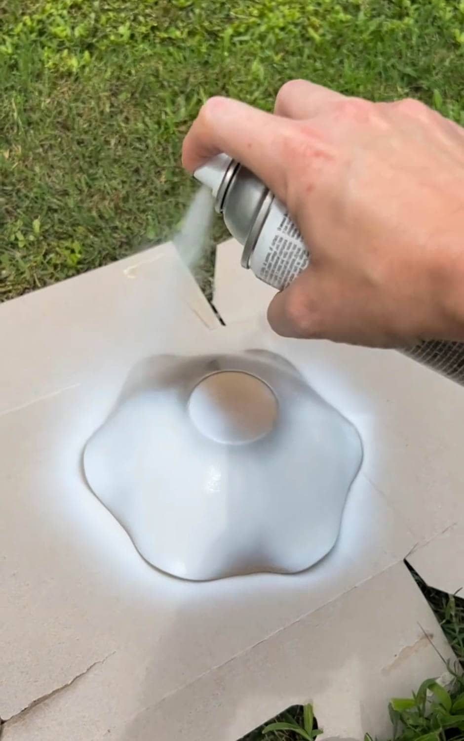 painting a scalloped bowl with white spray paint