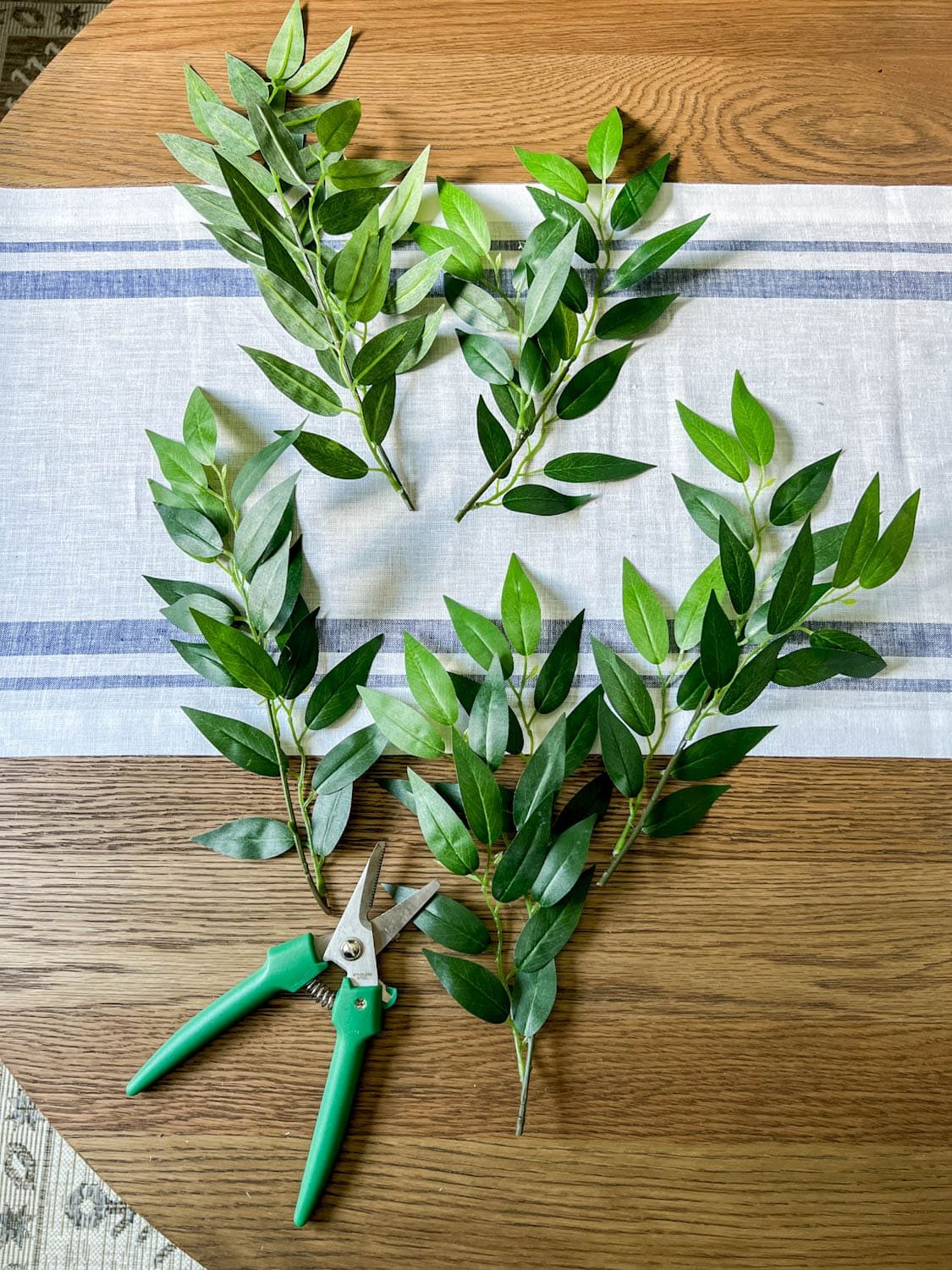 cutting ruscus to use in a vase arrangement