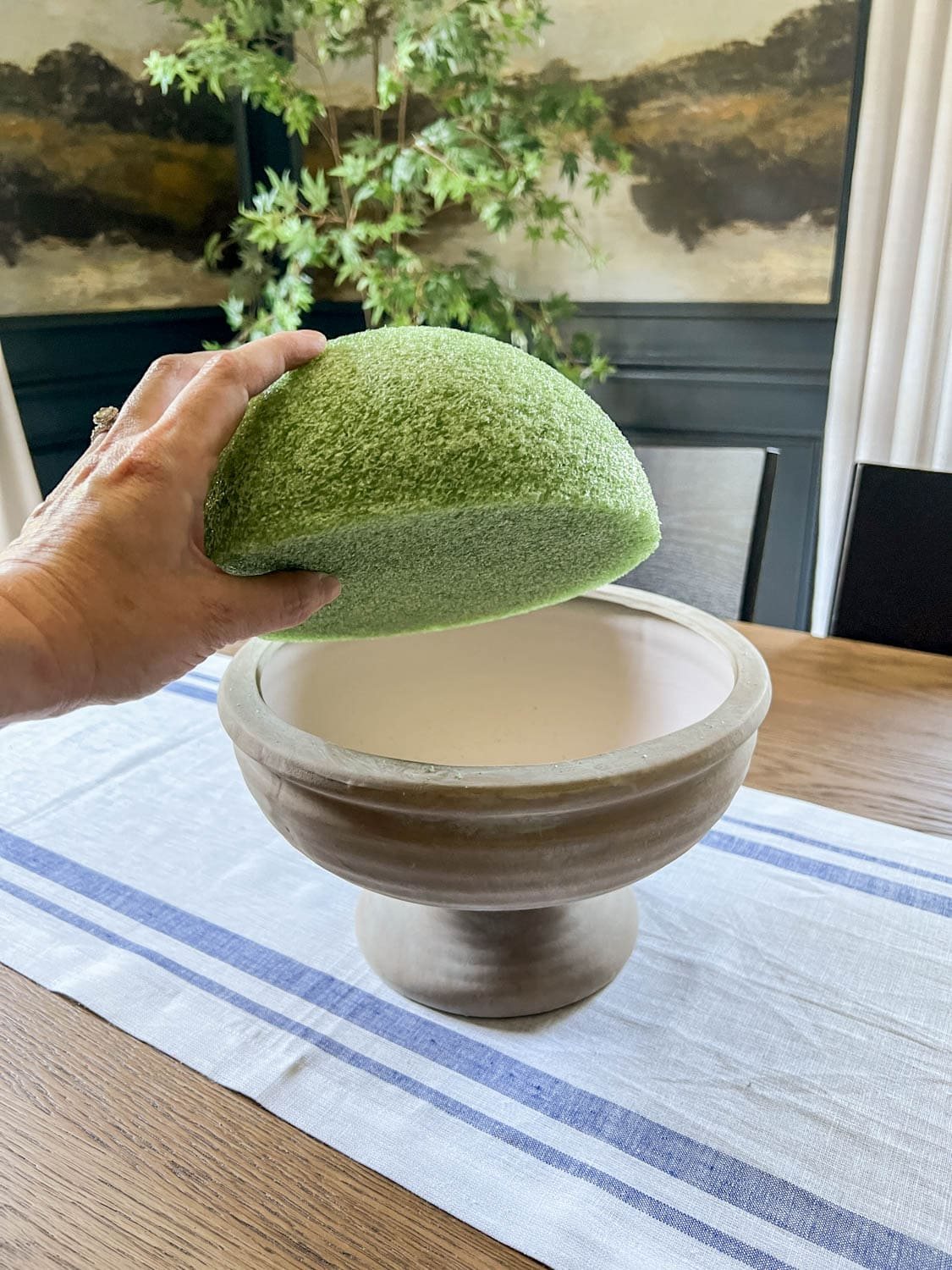 placing a half sphere of florist foam in a footed bowl to make DIY altar flower arrangement