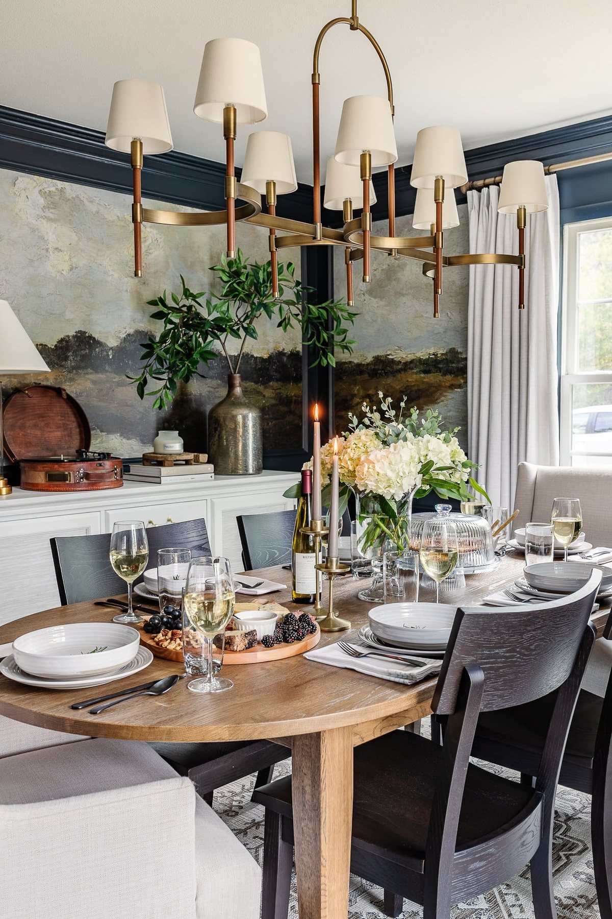 dinner table decor in a dining room with summer centerpiece, neutral dinnerware, and charcuterie board