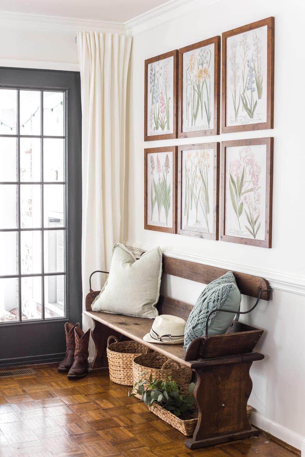 Simple Spring Home Tour | Craigslist bench with baskets underneath for a makeshift mud room and free botanical prints for spring.