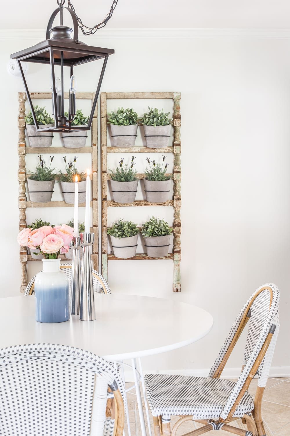 Simple Spring Home Tour | Breakfast nook informal dining with French bistro chairs and wall planter made from antique banisters