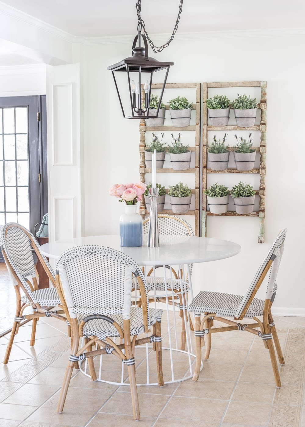 Simple Spring Home Tour | Breakfast nook informal dining with French bistro chairs and wall planter made from antique banisters