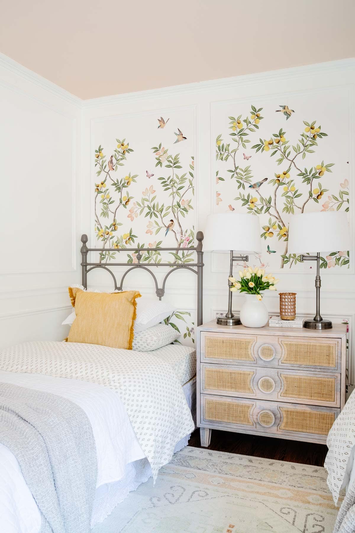 twin beds in a toddler girl bedroom and chest used as a nightstand