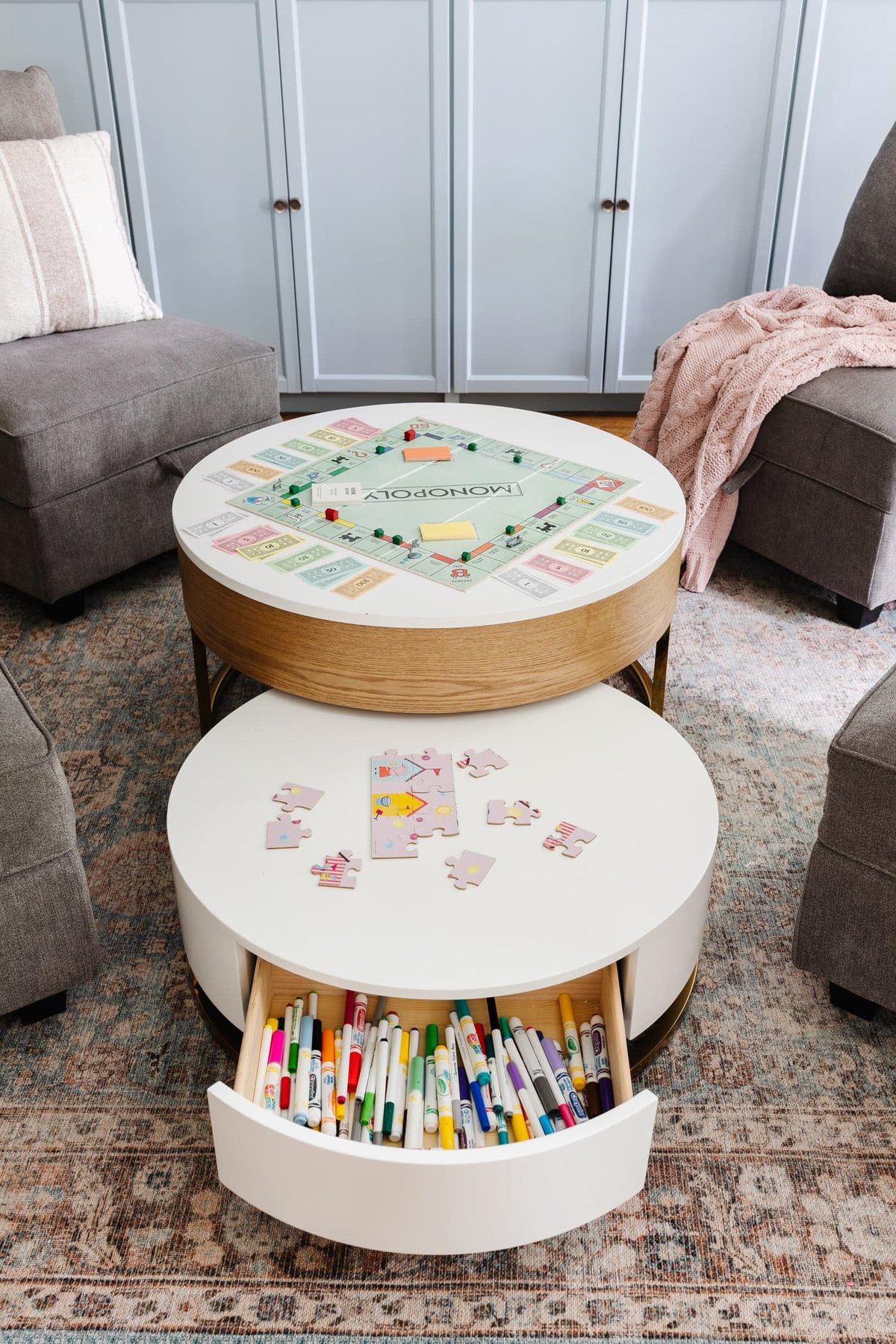 playroom organizer table with games, puzzles, and markers