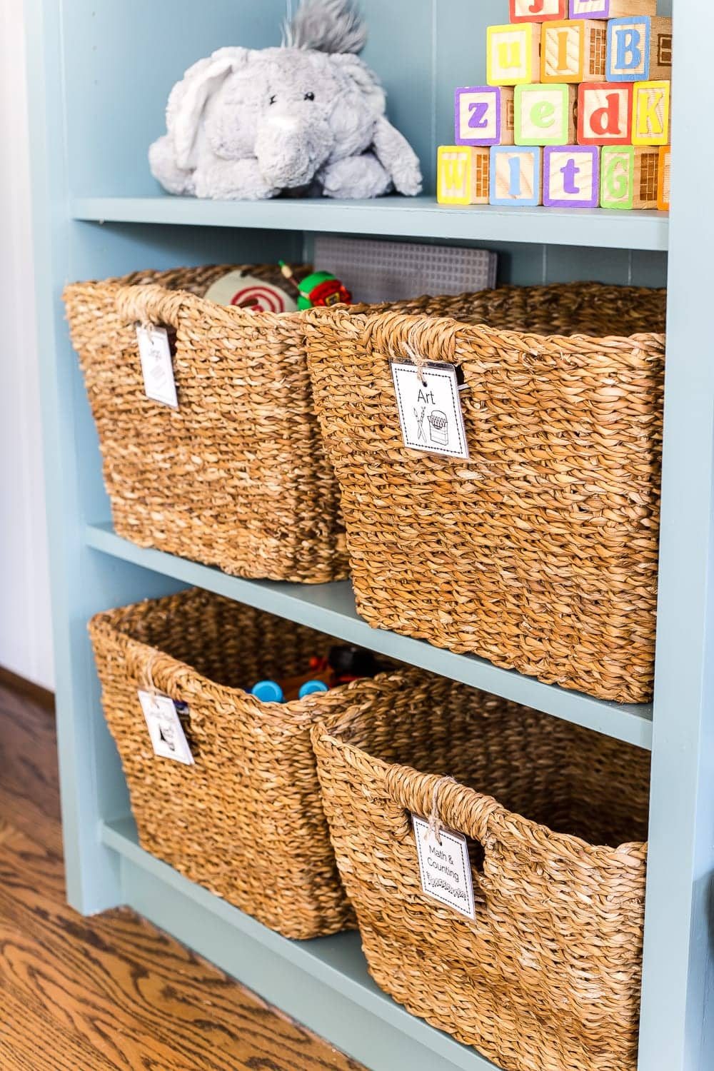 A dated, unorganized playroom gets a bright and whimsical makeover with organizational strategies, ideas for adding function, and DIY-able projects to create the perfect kid's space on a budget. #kidsroom #playroom #kidsdecor #toyorganizing