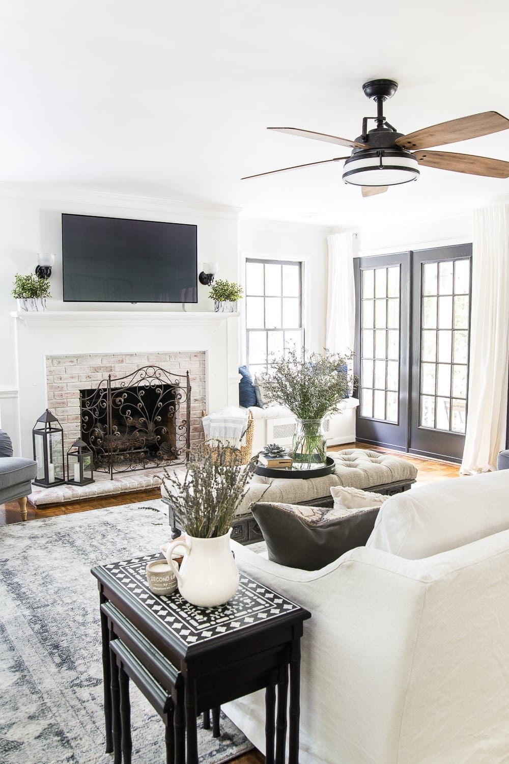 summer living room with limewashed brick fireplace