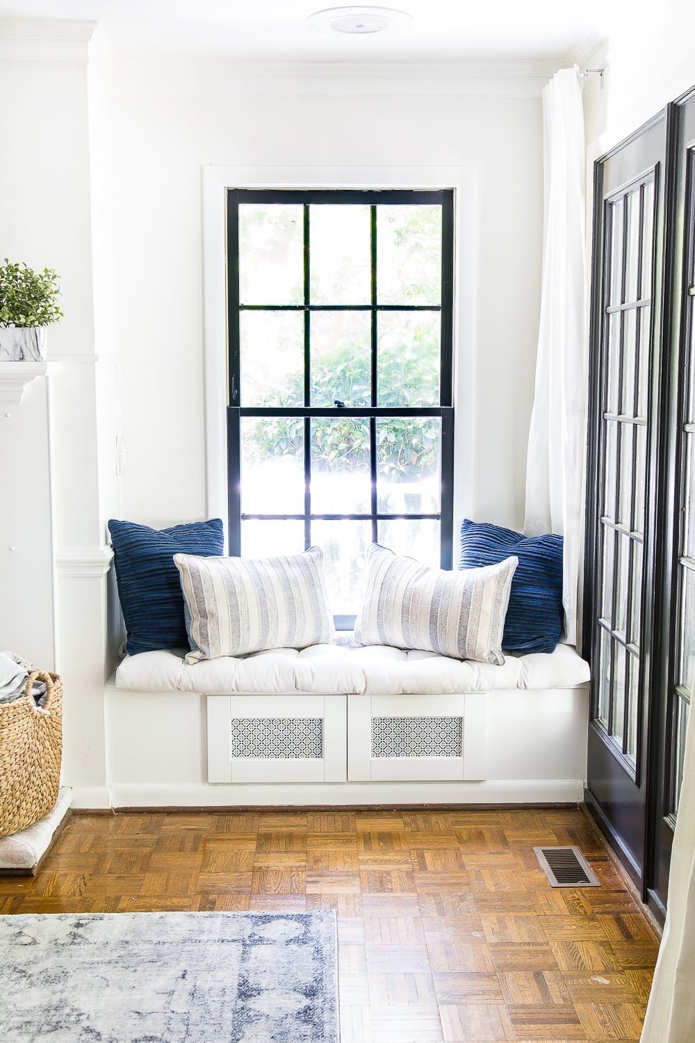 DIY window seat made from a kitchen cabinet to hide TV cable boxes and gaming system