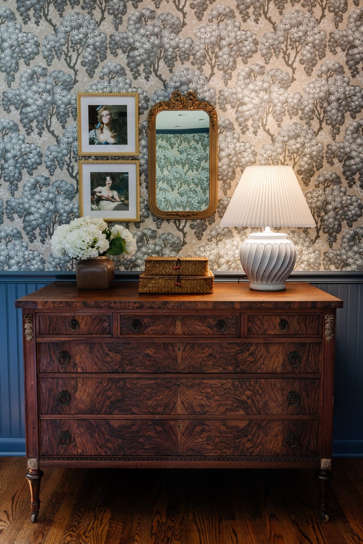 burl dresser with swedish wallpaper and blue beadboard + antique altered portraits