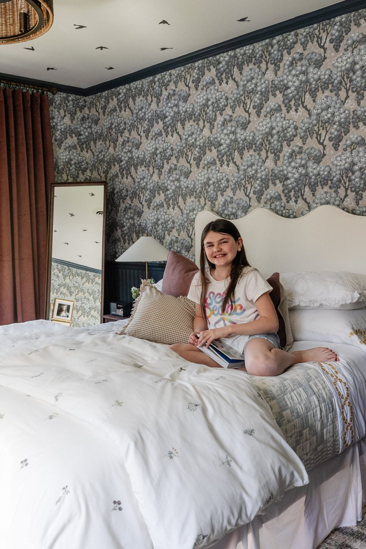 girl on bed in swedish cottage bedroom