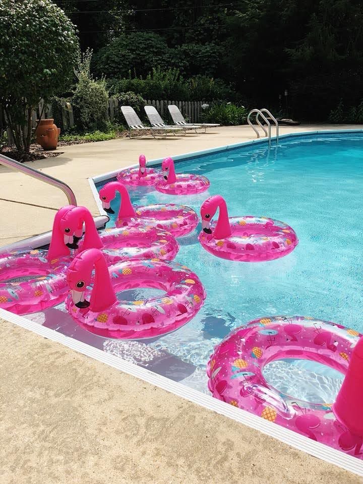 flamingo themed pool party using flamingo pool floats as decor and party favors