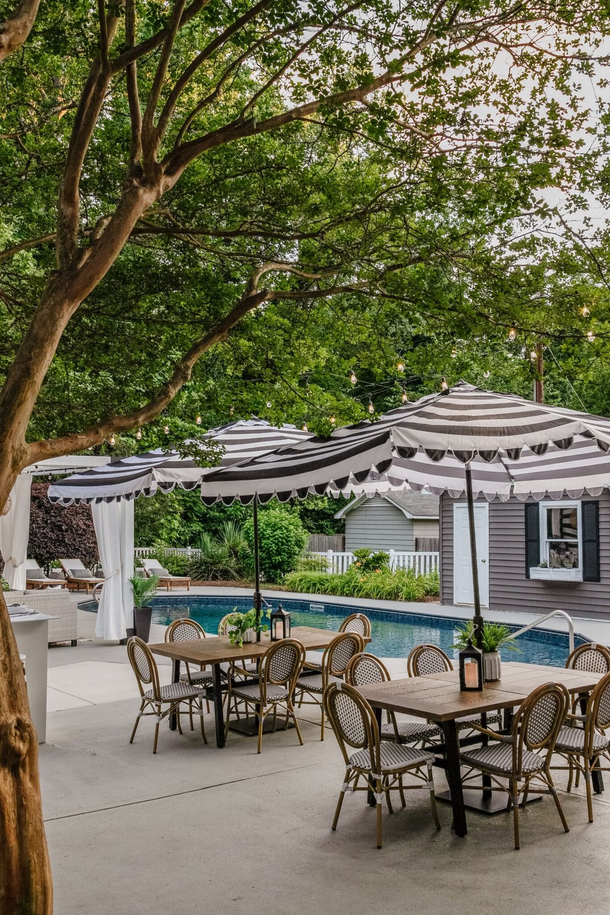 backyard pool with painted concrete deck patio tables pool shed and backyard cabana
