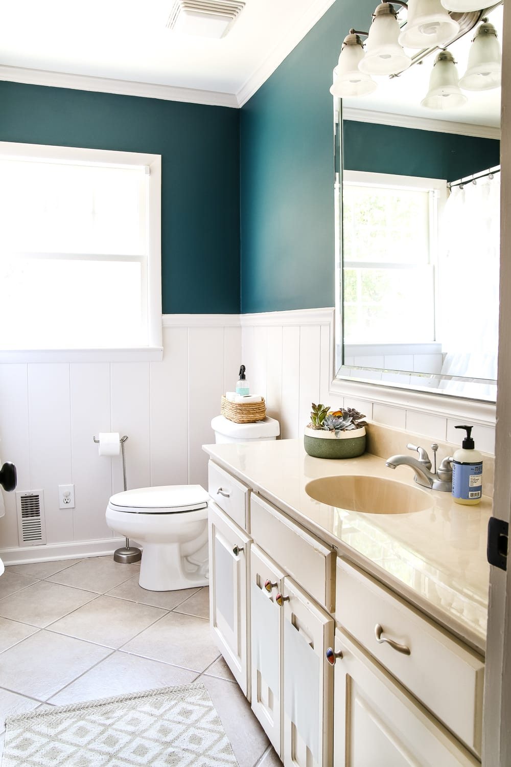 Teal Painted Bathroom Makeover | unigumushane.com - A boring, dated beige bathroom gets a fresh teal painted makeover with Magnolia Home Paint in the color Weekend and Ben Moore Simply White and Wrought Iron.
