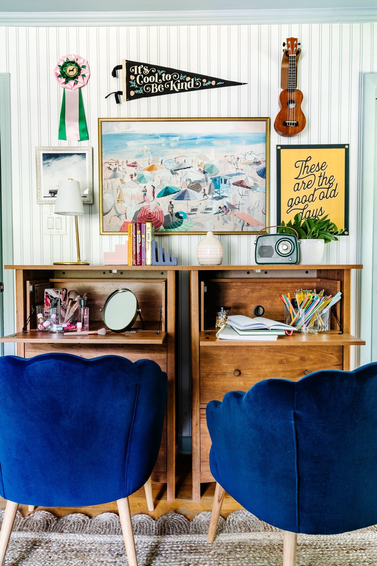 beach bedroom gallery wall with camp art and coastal paintings behind bedroom desks
