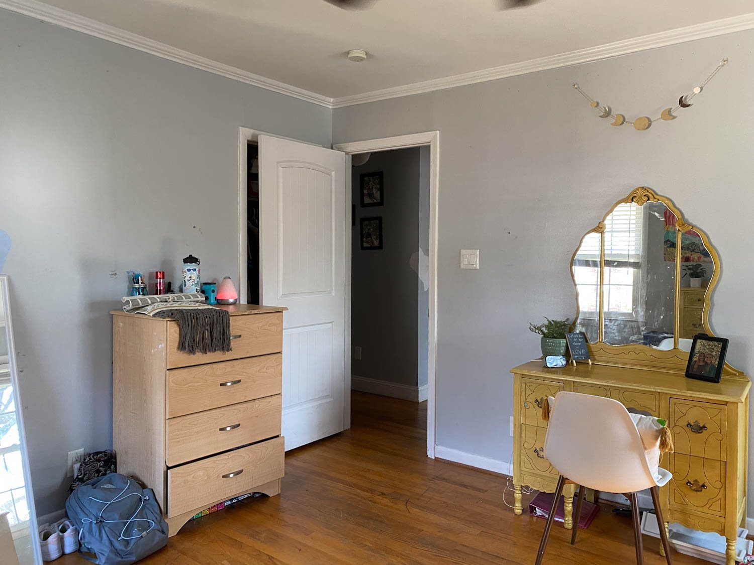 shared teenage bedroom before with dresser and desk vanity