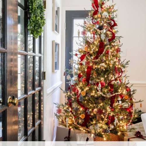 fake Christmas tree with red ribbon, wood beads, and ornaments