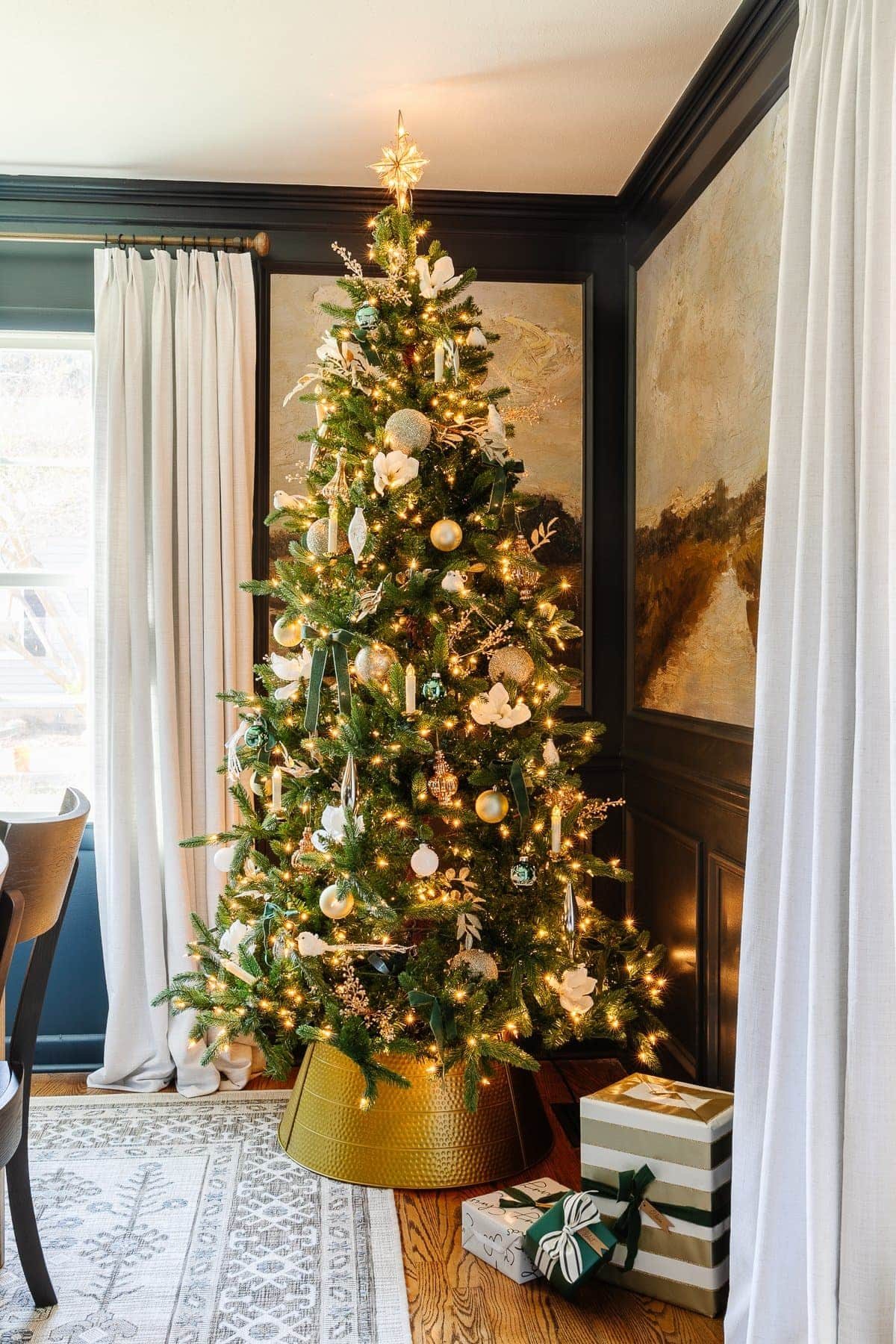 traditional Christmas tree with simple ornaments and faux flowers in a dining room