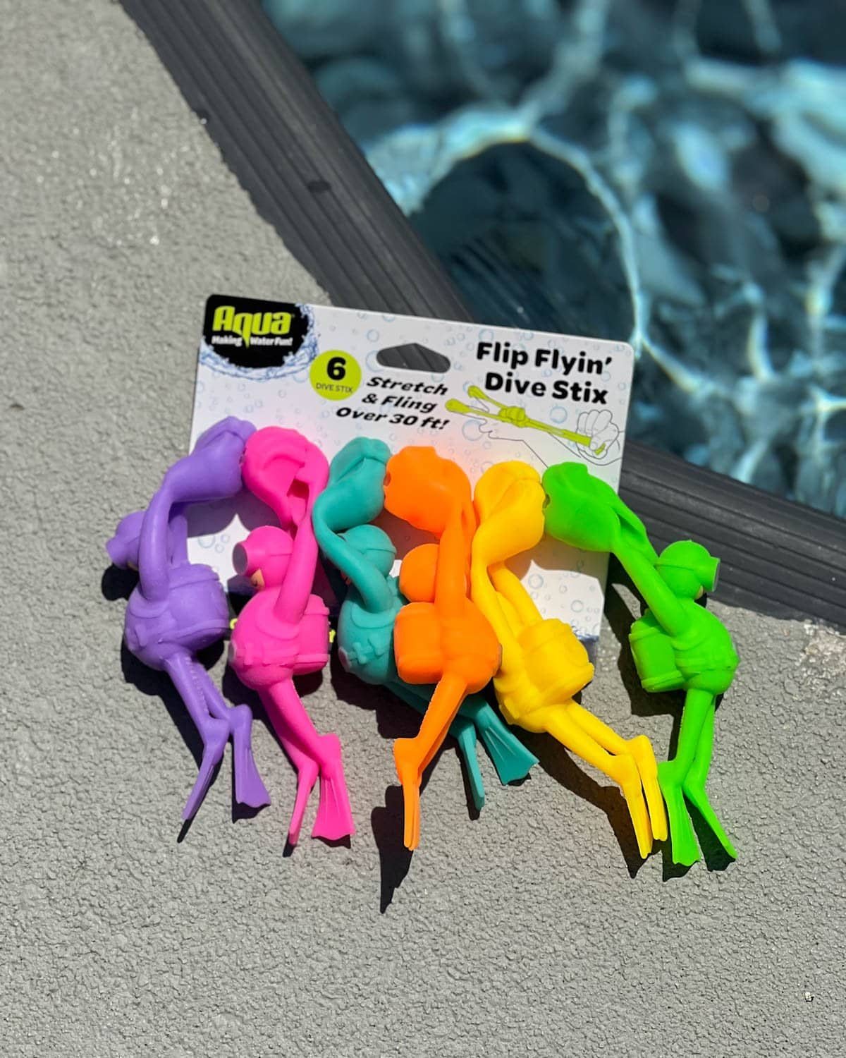 pack of Flip Flying Dive Stix pool toys on the side of a swimming pool