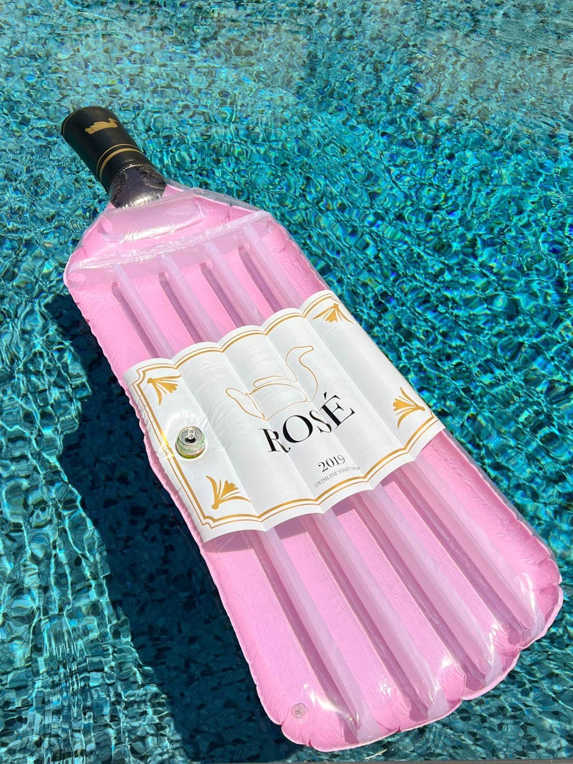 wine bottle shaped pool float in the water