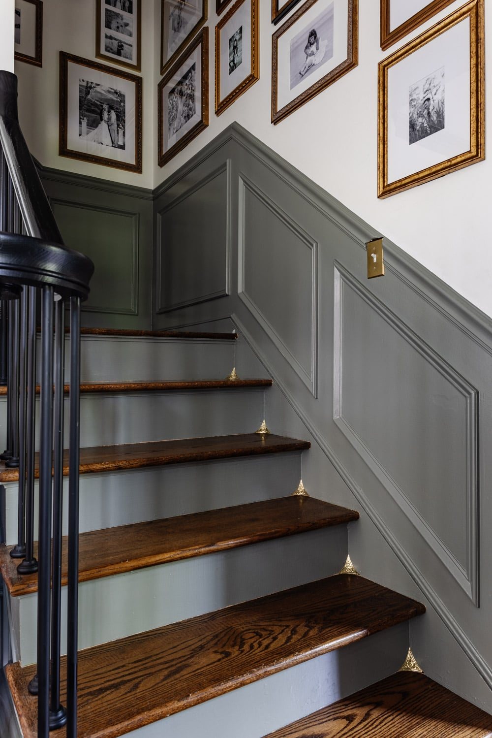 dust corners on a staircase with gallery wall