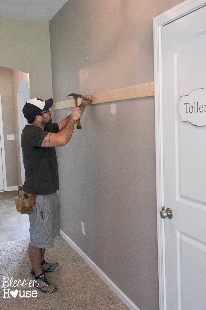 nailing board to wall to start board and batten