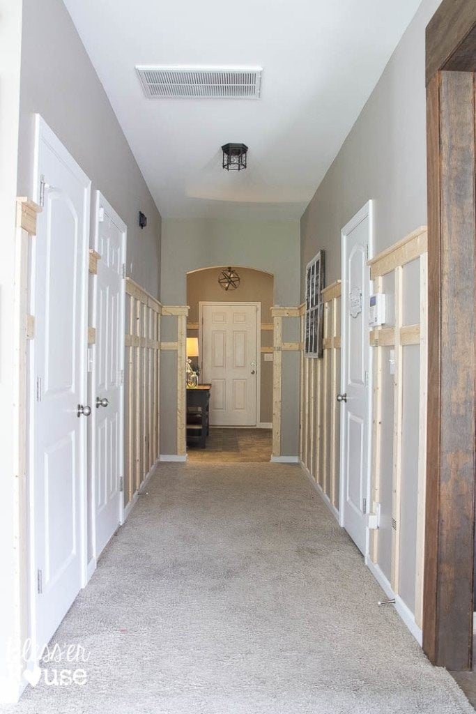 adding board and batten wainscoting to a dark hallway with a shelf detail