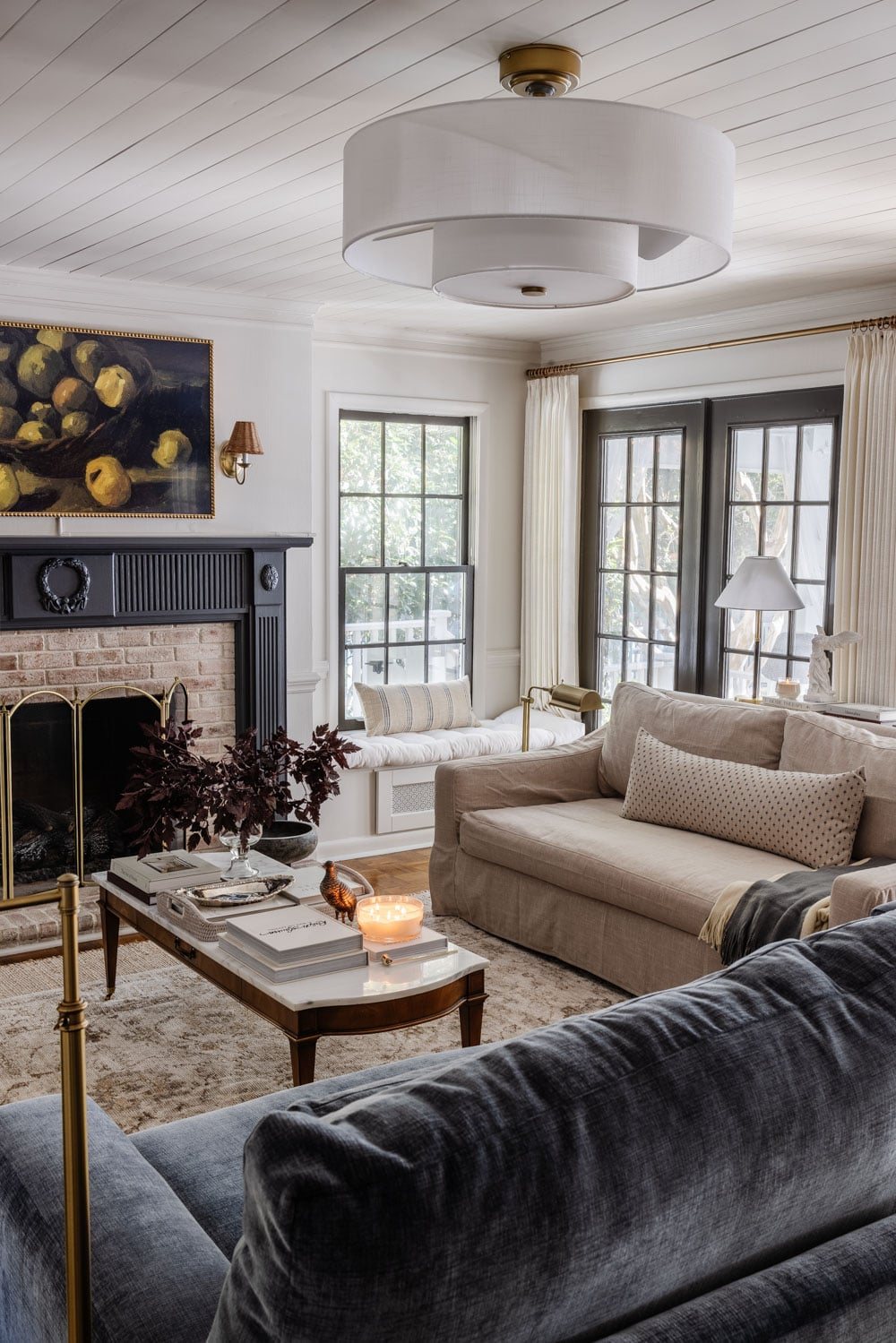 living room with blue fireplace mantel, marble coffee table, and modern fandelier