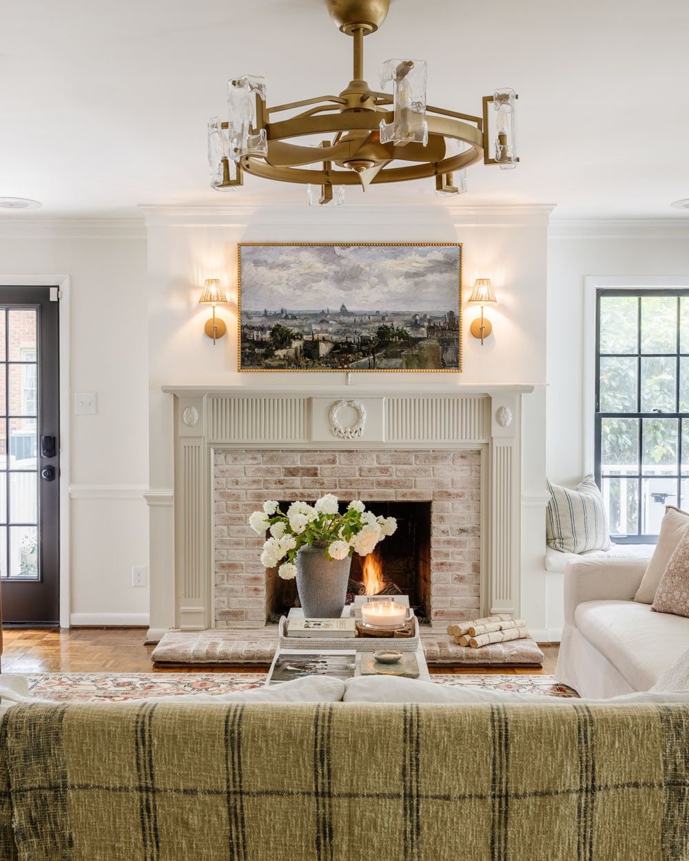 white living room with black doors and limewashed brick fireplace