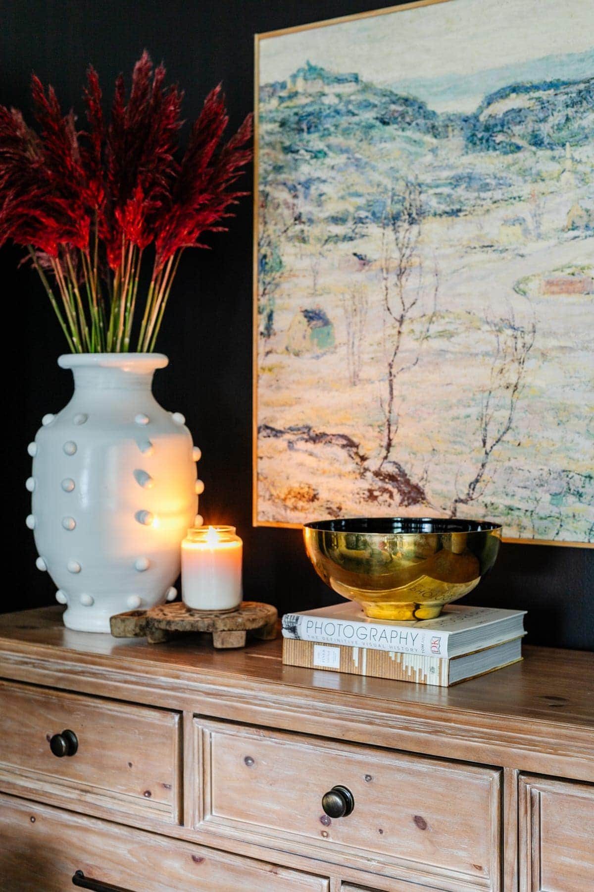 coffee table books styled on a bedroom dresser