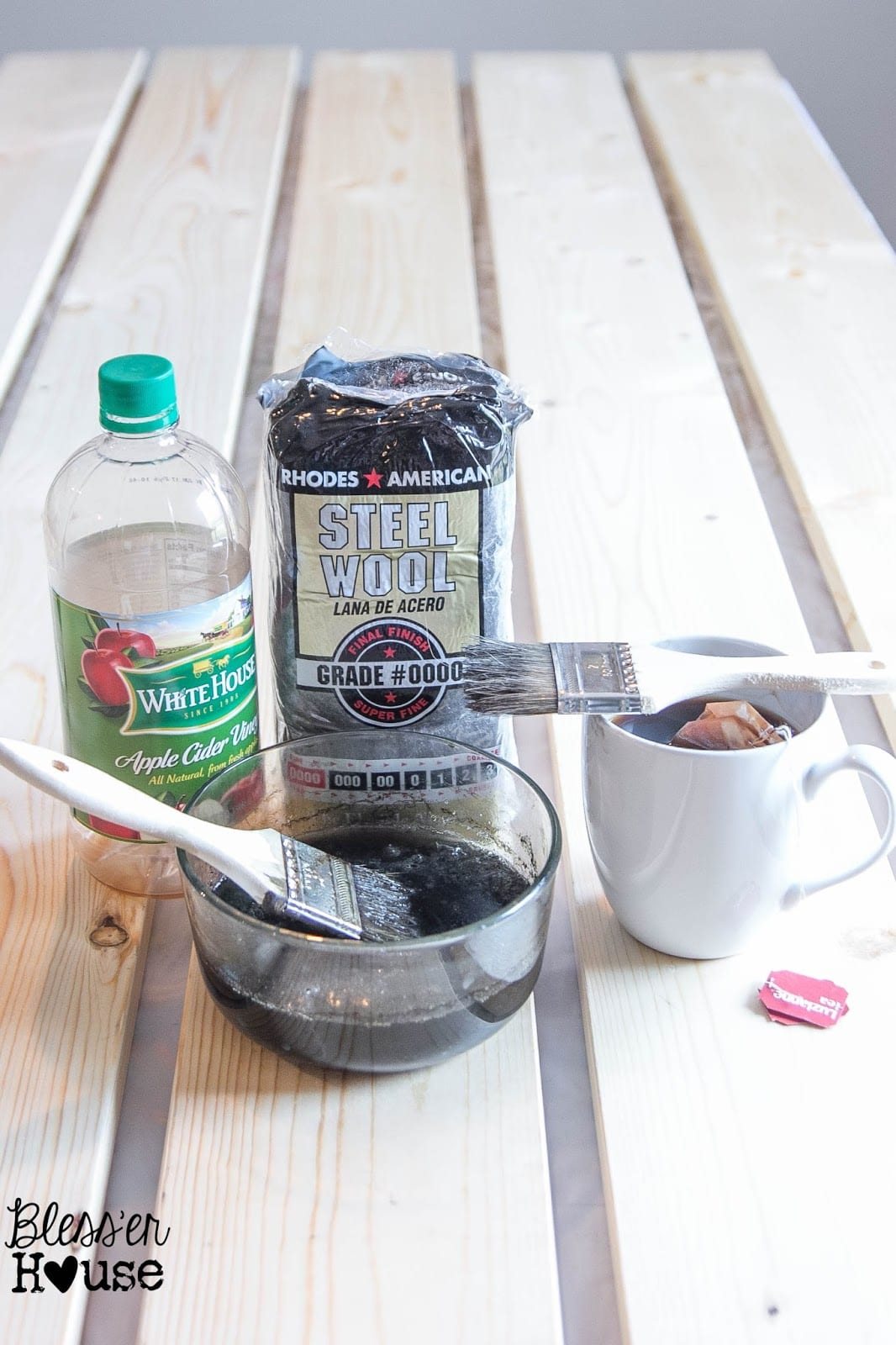 The ingredients you need for this DIY all natural wood stain method are steel wool pads, some black tea, apple cider vinegar and a few paint brushes.
