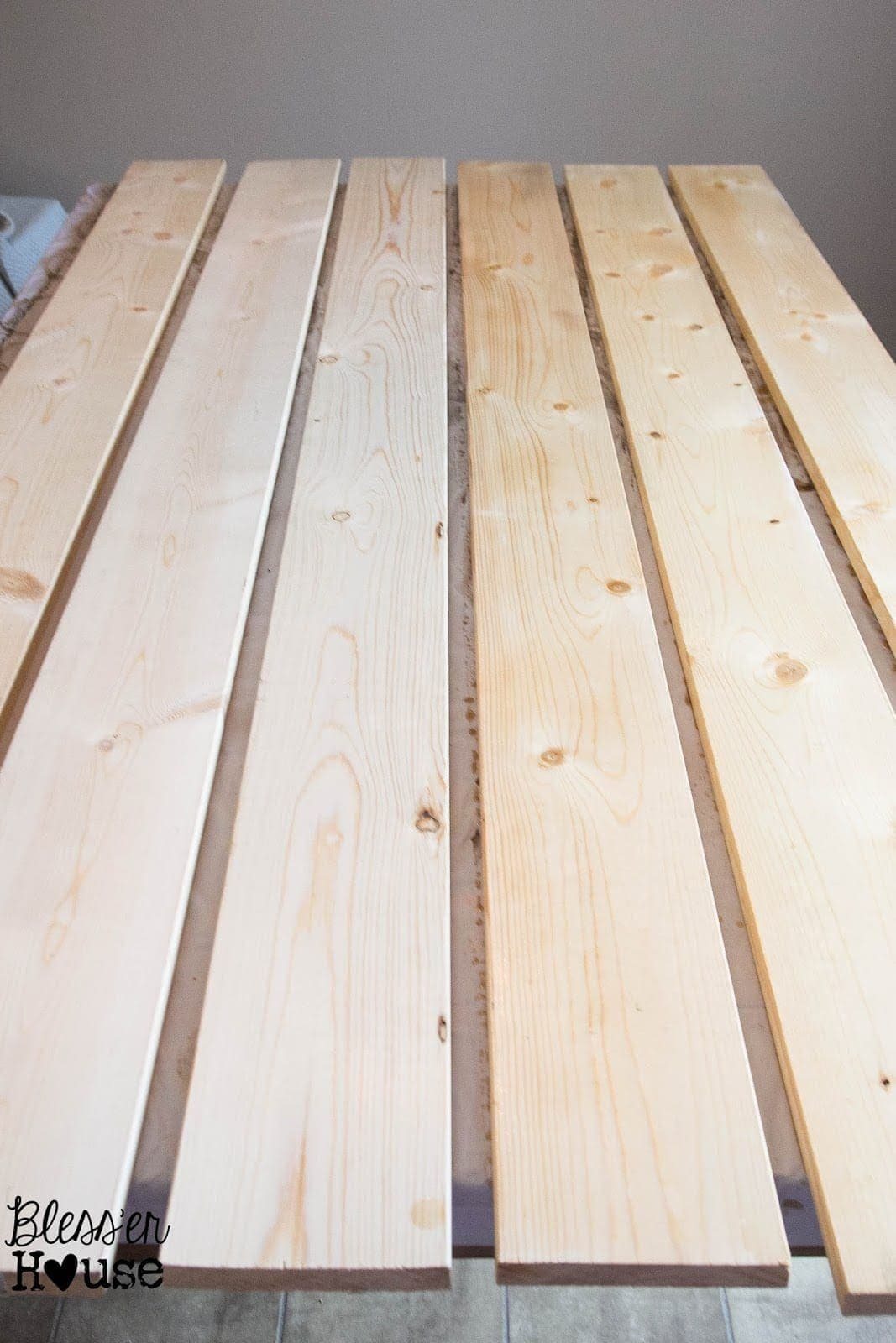 A side by side comparison of what regular lumber looks like compared to black tea stained lumber (on the left).