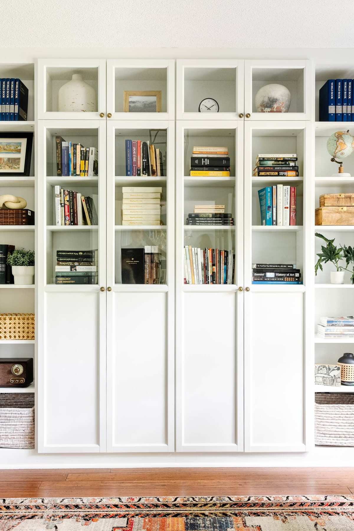 books on a bookshelf behind cabinet doors