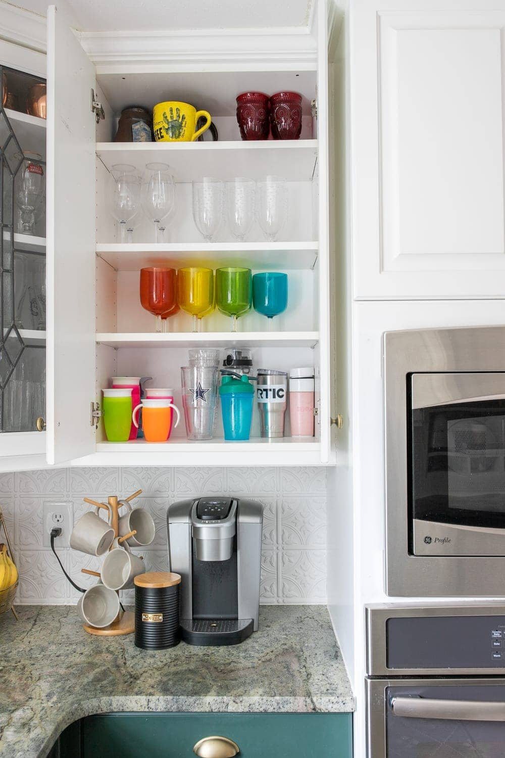 coffee station on kitchen counter and cabinet with cups