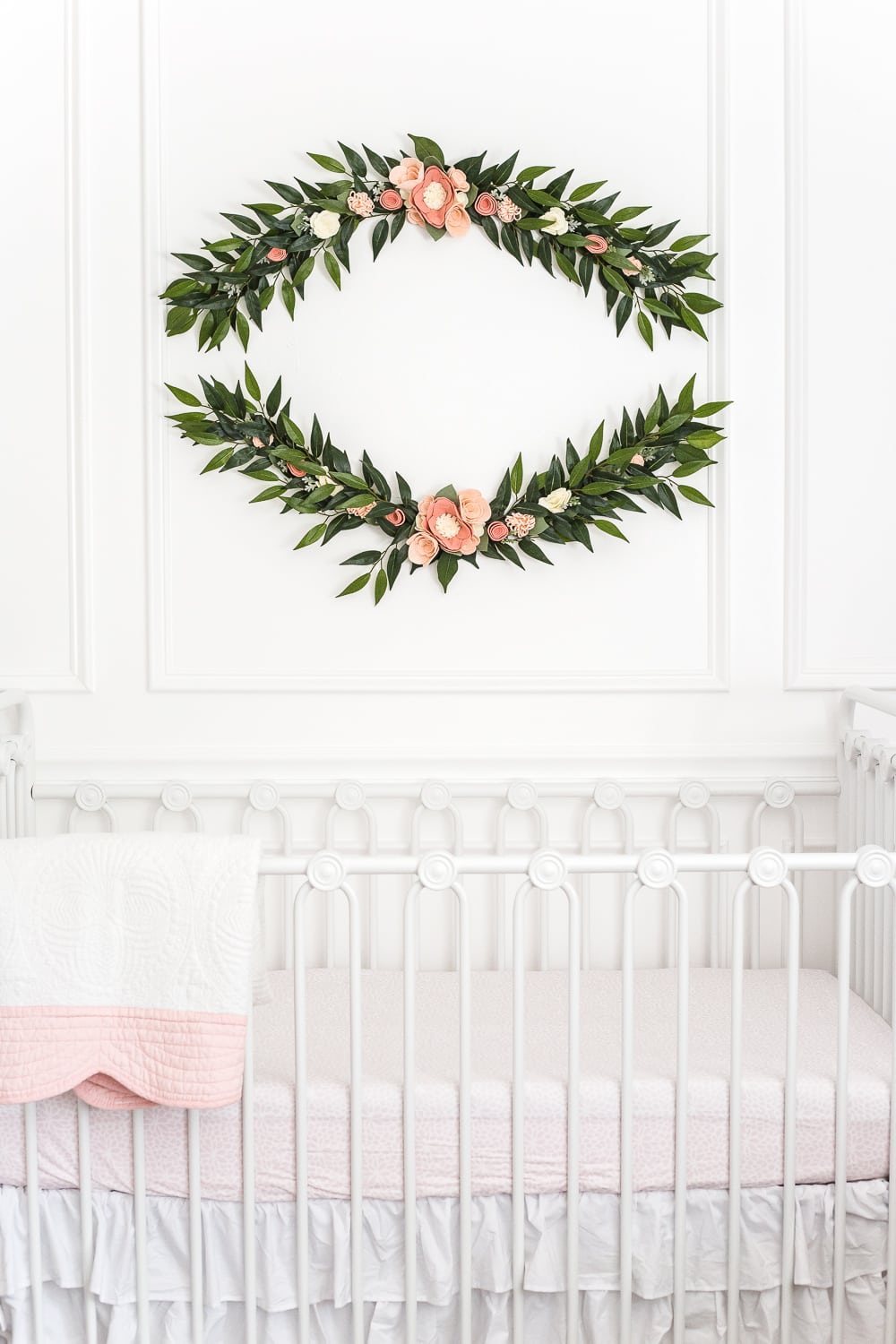 An all white nursery makeover room reveal with classic, vintage style furniture, Anthropologie-inspired patterns and textures, and floral accents.