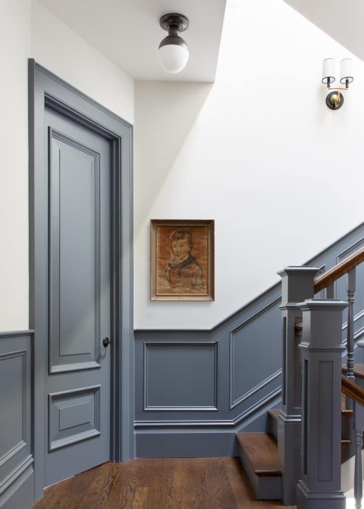 staircase with blue contrast trim and white walls