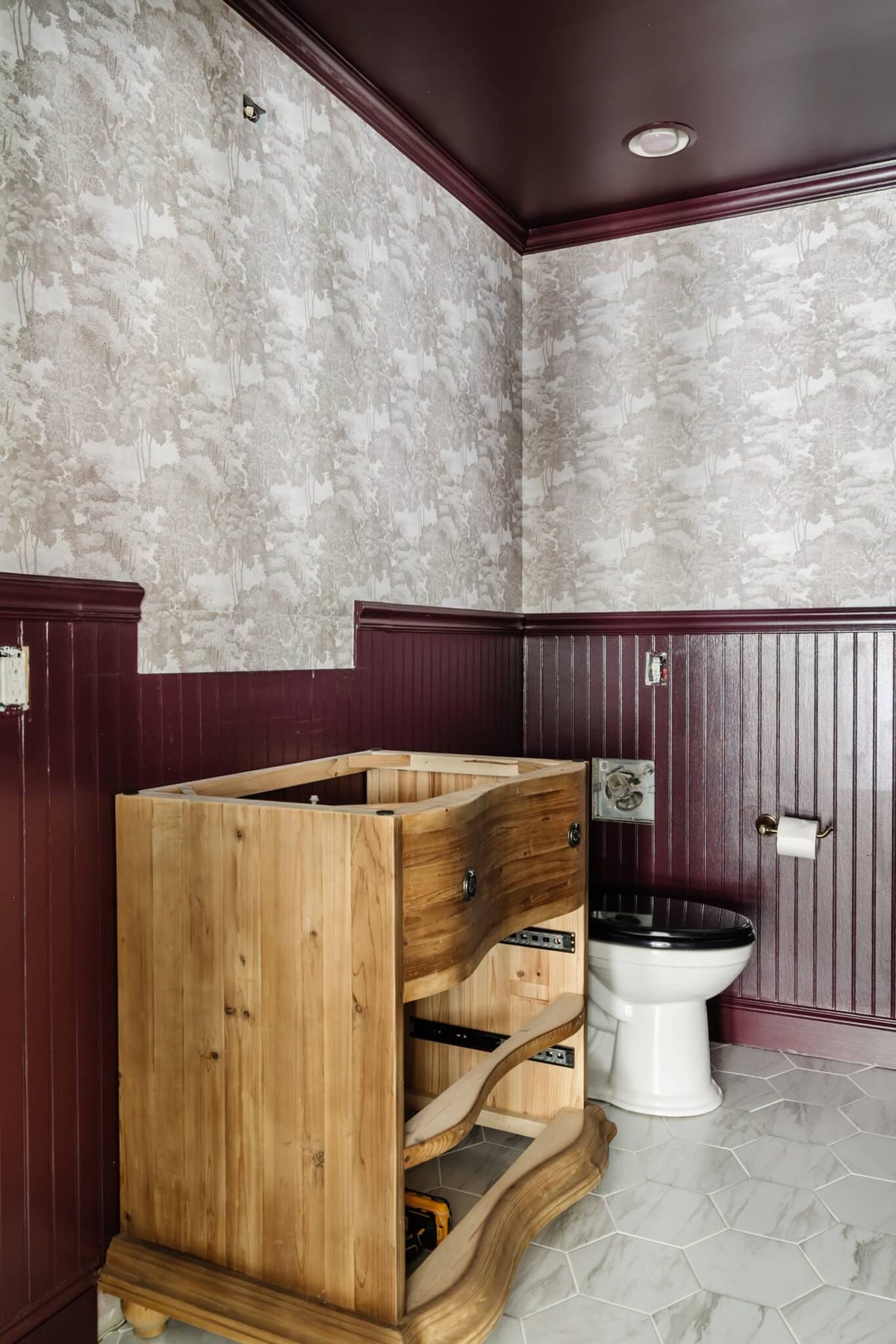 Farrow & Ball Brinjal paint with modern toile wallpaper Saint Sebastian in a powder room