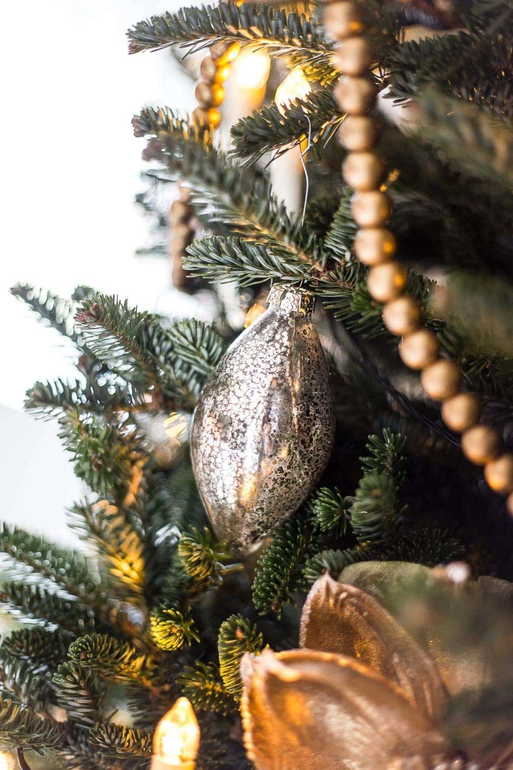 mercury glass ornament on a tree branch