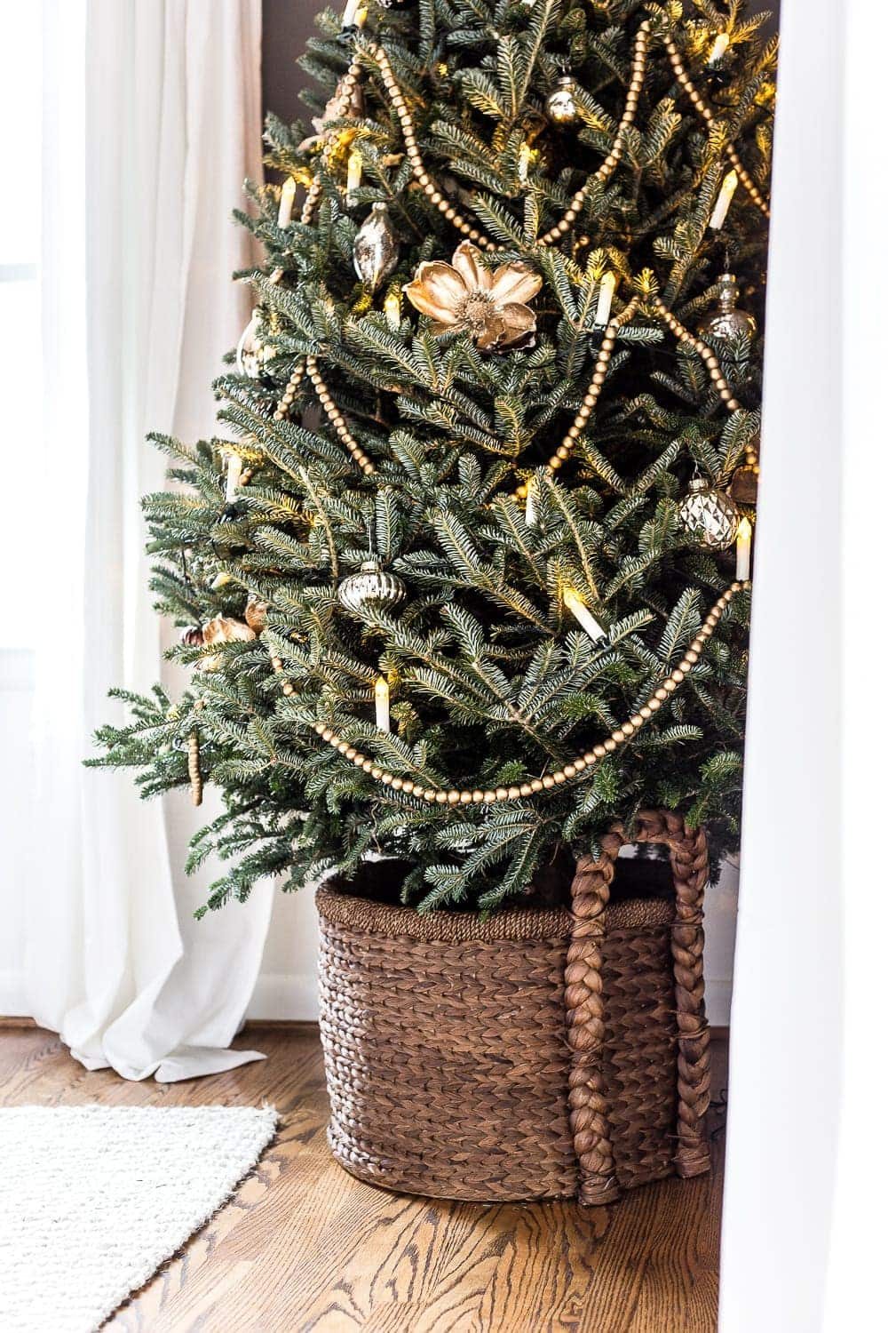 minimalist Christmas tree with garland, candles, and simple ornaments