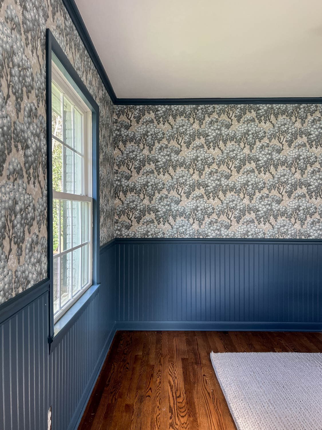 maximalist decor with beadboard painted Sherwin Williams Smoky Blue and vintage Scandinavian wallpaper pattern Sandberg Wallpaper Ragnvi Indigo Blue