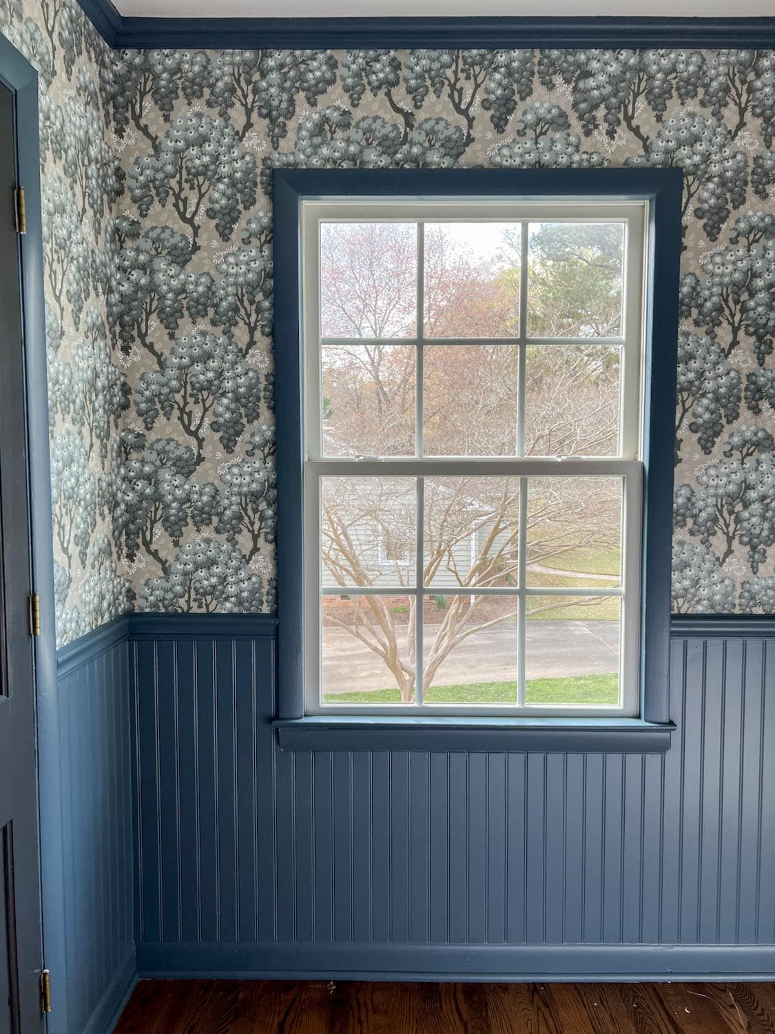bedroom with beadboard painted Sherwin Williams Smoky Blue and Sandberg Wallpaper Ragnvi Indigo Blue