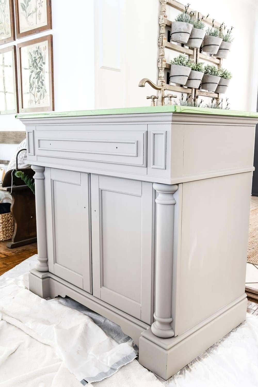 Weathered Gray Wood Look Vanity Makeover | unigumushane.com - A vanity gets a weathered gray wood look using just chalk paint and wax. Looks so much like real weathered wood in less time with less mess!