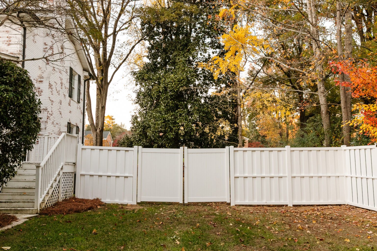 white vinyl fence installation in a backyard using Ply Gem