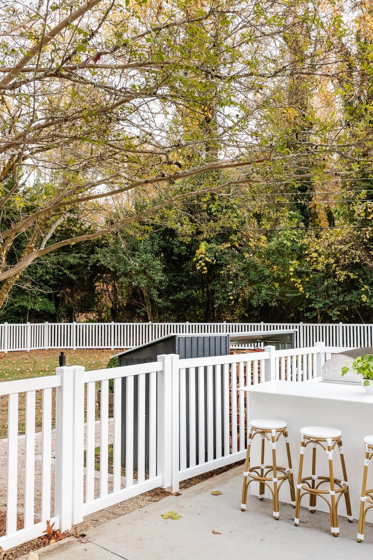 backyard with new white vinyl fence installation