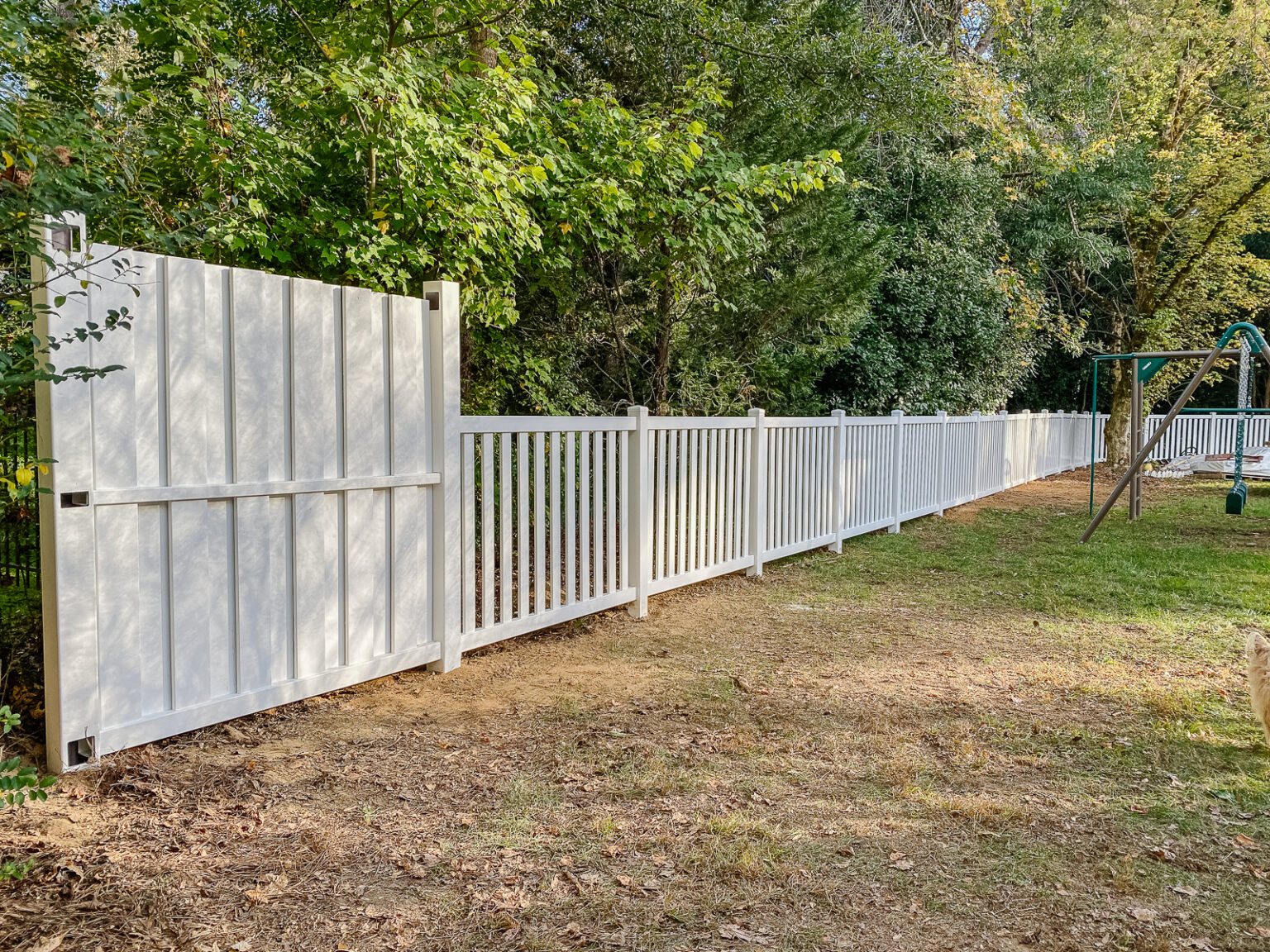 white vinyl fence installation with Ply Gem in a backyard