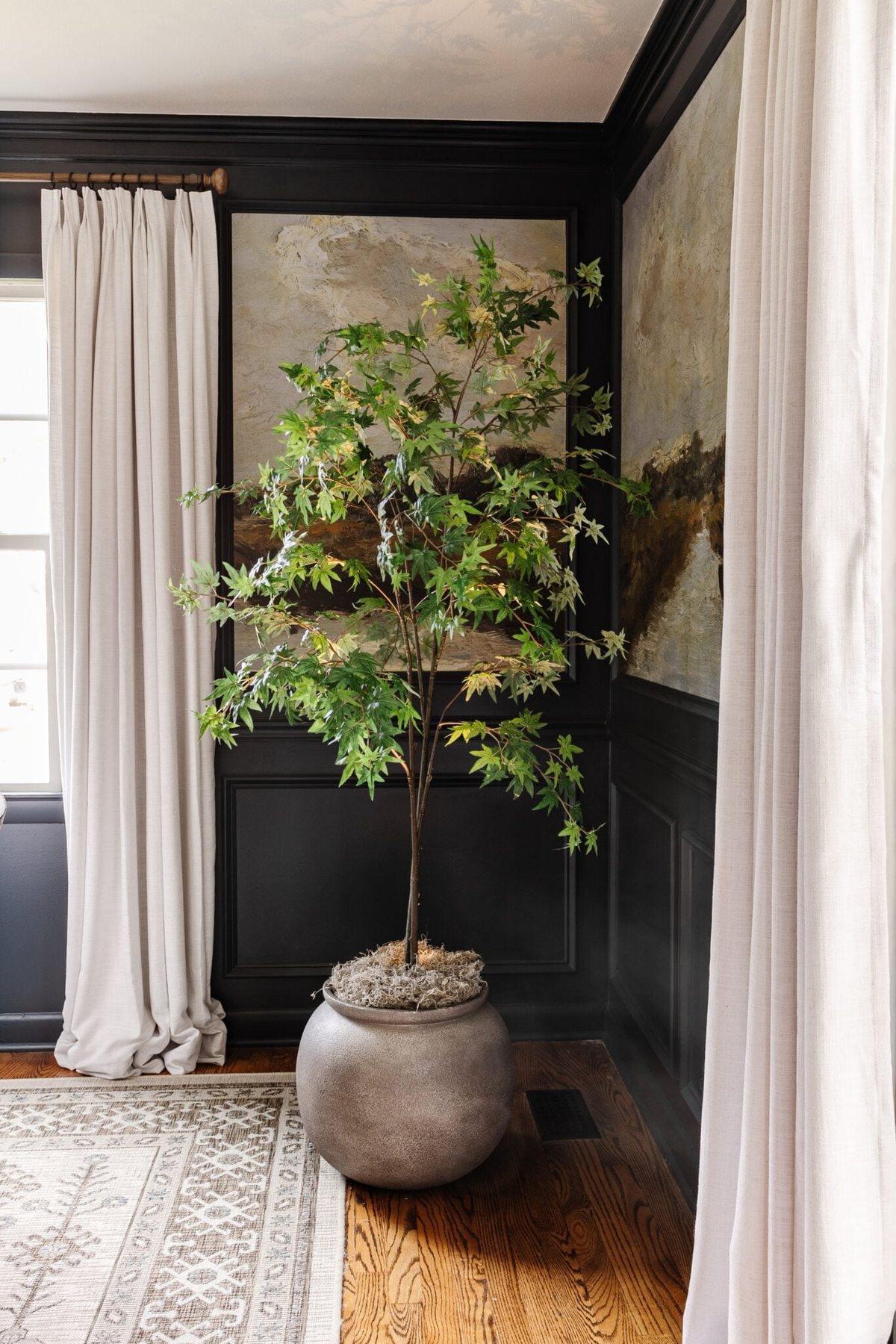 faux indoor tree in large planter with moss and uplight