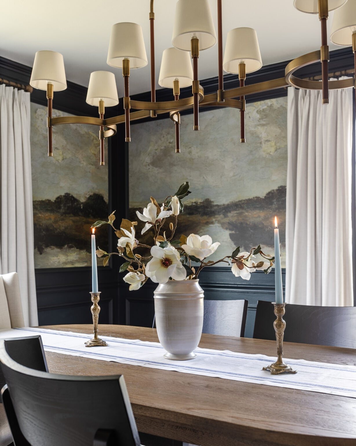 vase of faux magnolias on a dining table